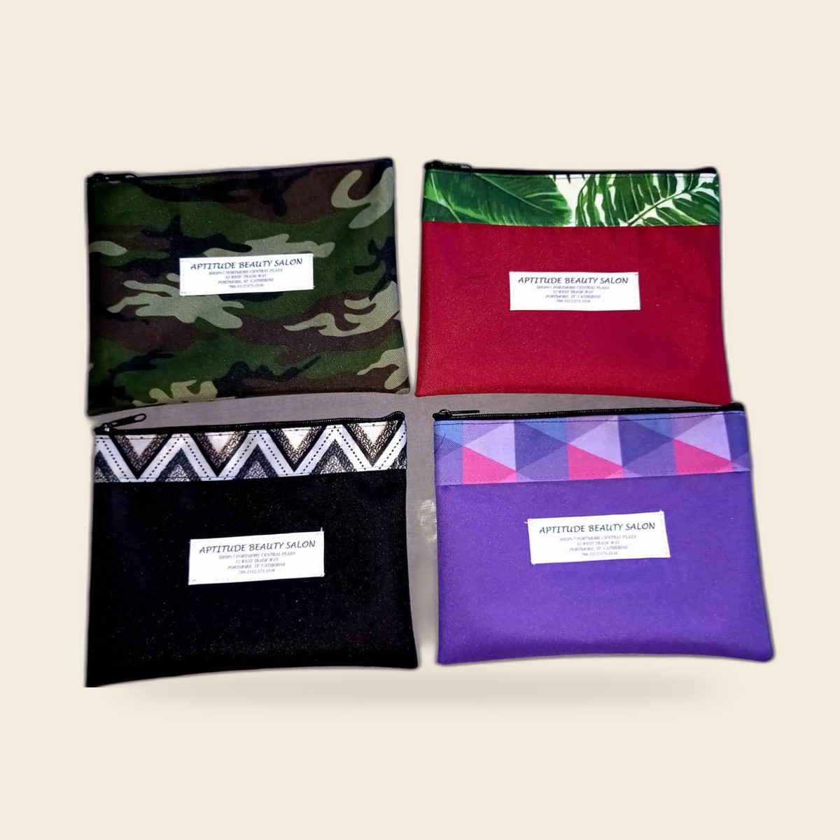 Aptitude Beauty Salon branded zip pouches in assorted colors